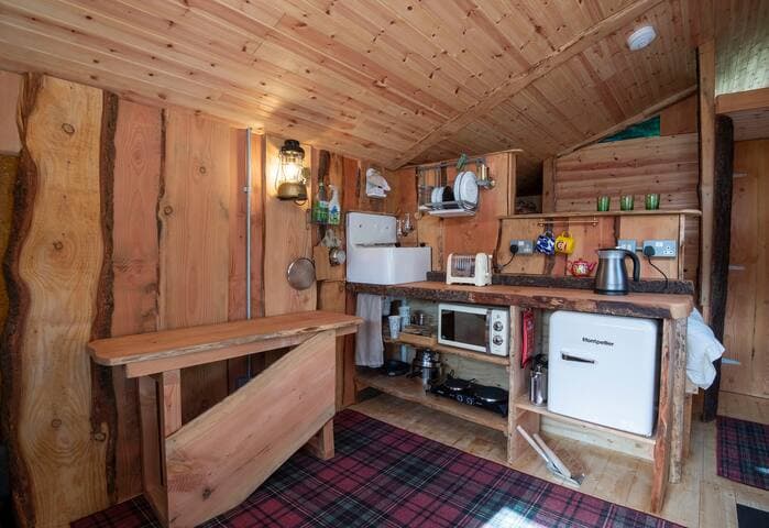 The compact but beautiful kitchen in Clanranald. The fixtures and fittings are mostly wood and metal, to cut down on plastic use. The mini-fridges we use are oh so quiet for your night-time comfort