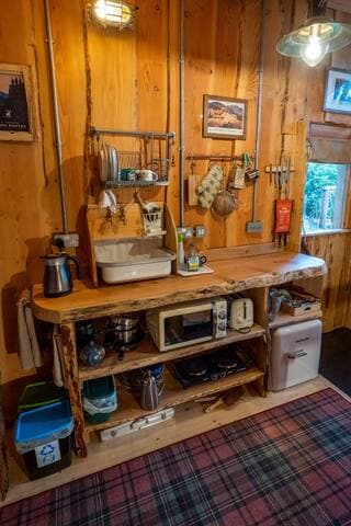 The compact but well-equipped kitchen with natural wooden slab worktop