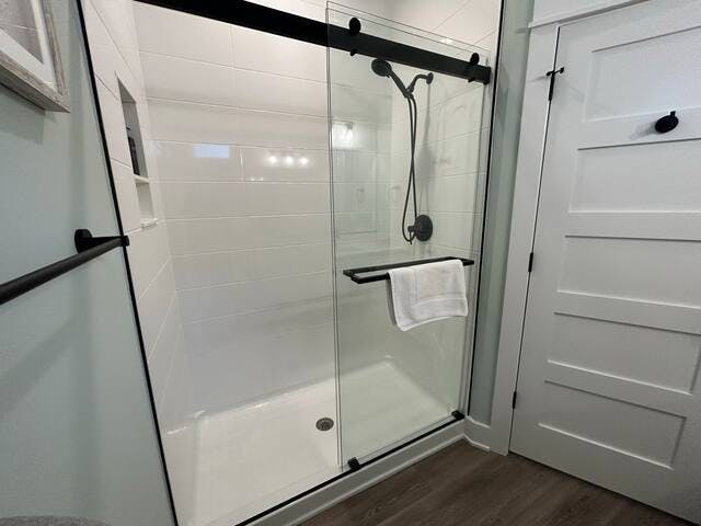 Large shower in the master bathroom is tiled and includes a massage shower head.  