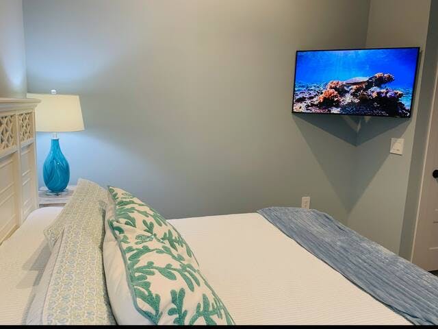 King bedroom with 43 inch Smart TV on adjustable mount.  