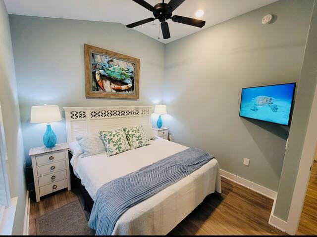 King bedroom with 4-drawer nightstands and ceiling fan. 