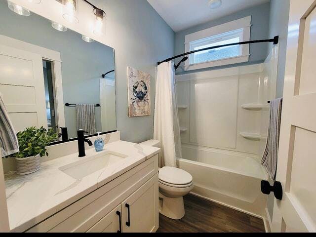 Guest bathroom has a tub and shower. 