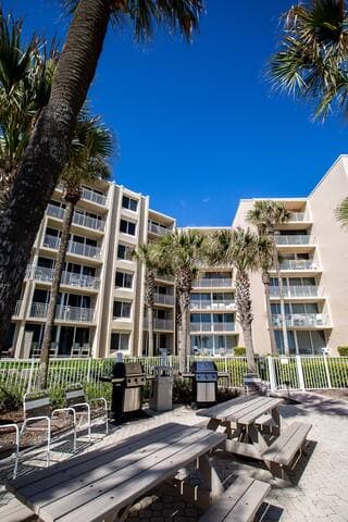 Outdoor seating and BBQ propane grills that are free to use.