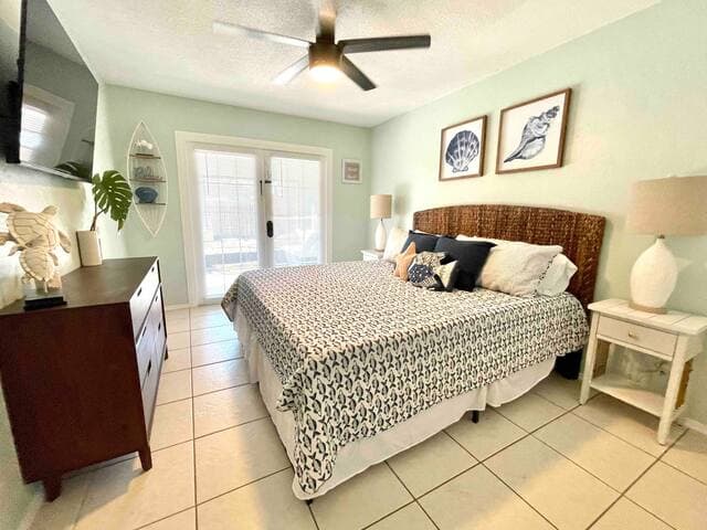 Primary bedroom features a king-size bed, smart TV and plenty of space to store your belongings. French doors lead to screened-in patio.