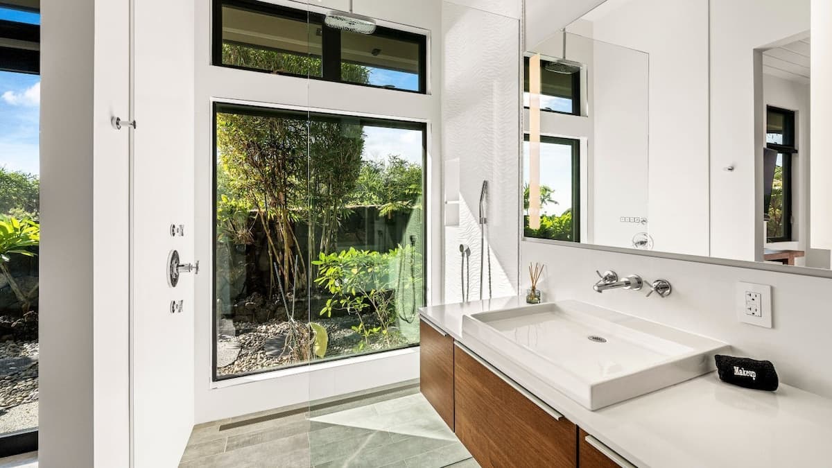 Bedroom 5 en-suite bath including shower, sink, and toilet. Power shades.