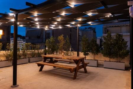 Shared rooftop gym on the 4th floor—(same umbrellas), open to all guests.
Your private garden waits just outside your suite downstairs.