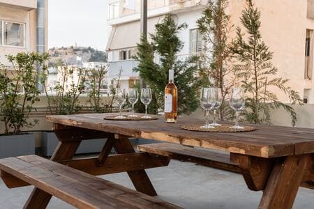 Shared rooftop gym on the 4th floor—(same umbrellas), open to all guests.
Your private garden waits just outside your suite downstairs.