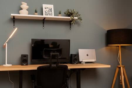 Next-level office setup: smart lights, booming speakers, and a desk that moves with you.