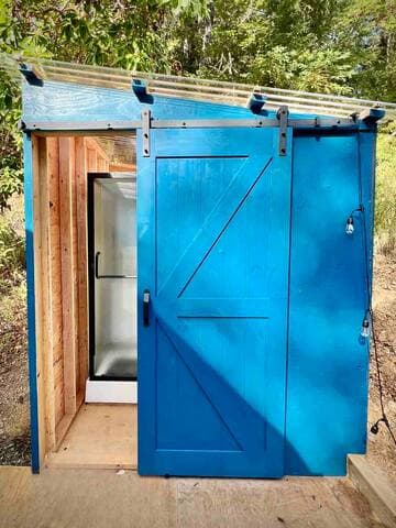 Private bathroom next to dome has sink and hot water shower