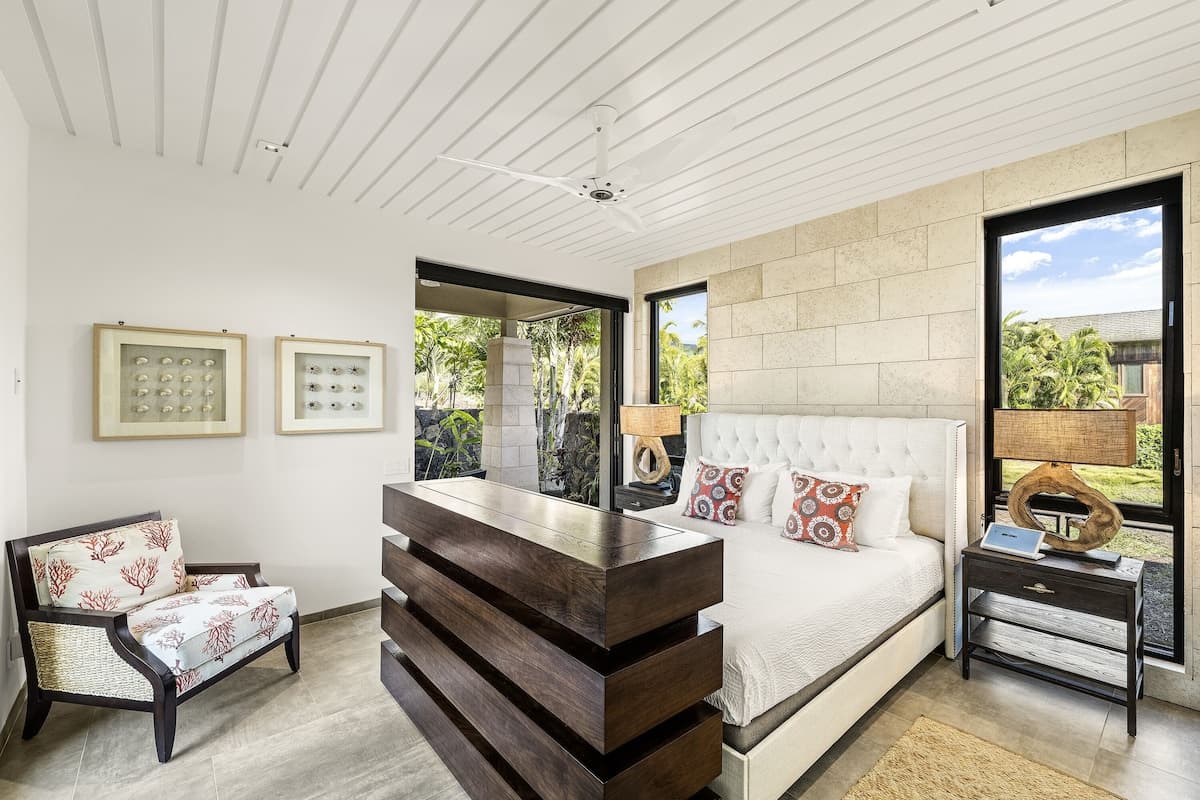 Bedroom 4 suite, main floor with Cal-King bed and hidden TV console