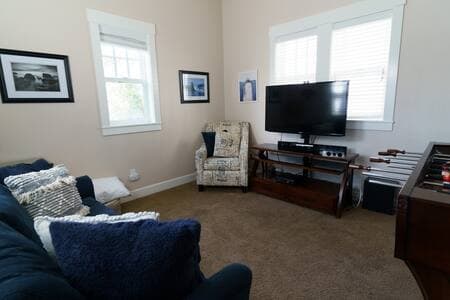 Our game room has a queen-sized pull-out bed, as well as a game system. TV, and foosball game. It is in the upper floor of the ADU building, and has its own entrance.