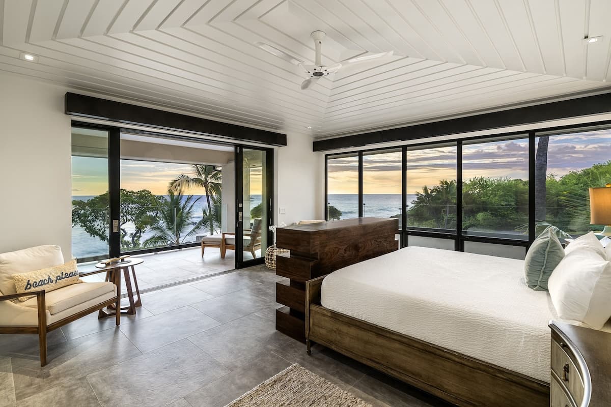 Primary bedroom, upstairs with Cal-King bed, private lanai, and hidden TV
