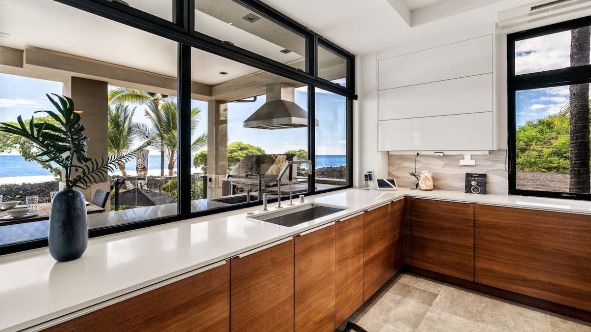 Kitchen with large windows, sinks, and plenty of counter space