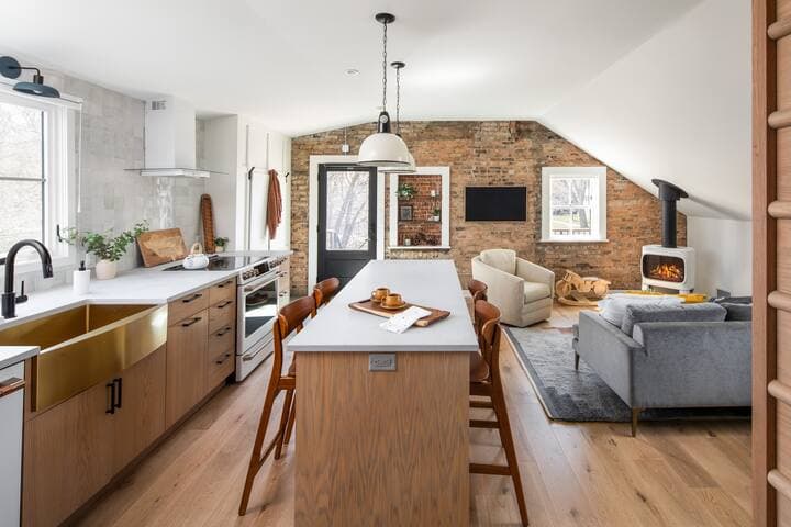 Ceilings were raised to give the space a more light and airy feel. Reclaimed light fixtures by Fixt.