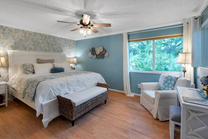 Primary bedroom features king-size bed, ensuite bathroom and desk.