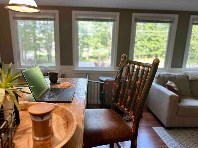 The living room has a bar height seating area which is a comfortable place to catch up on work while enjoying the living room views
The hand made rustic chairs overlook the playroom and provide additional seating in the living room as well