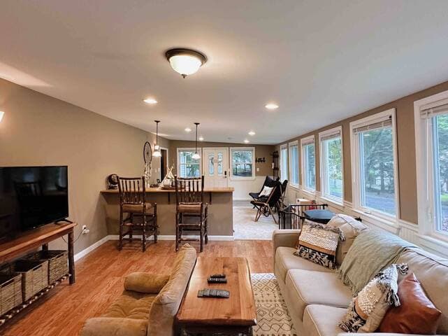 The large front room has space for the whole family with a playroom on one side and family room on the other. The windows span the full length of the room and face the lake
