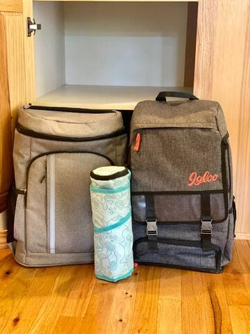 Insulated picnic backpacks with cheese board and to-go wine tumblers.