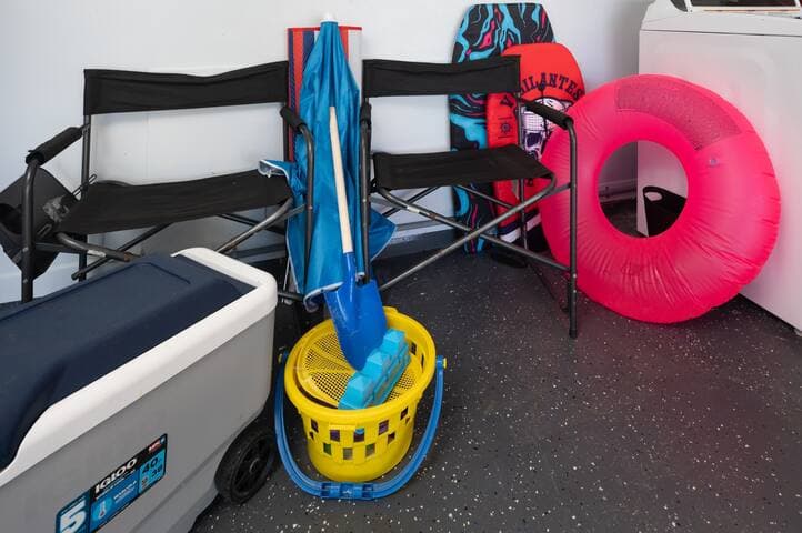 Sand toys, boogie boards, lawn chairs and cooler provided in the garage.