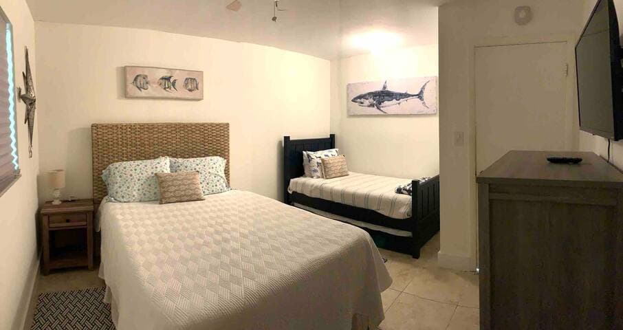 Guest bedroom with New queen Tuft & Needle bed plus New Zinus cooling memory foam twin w/trundle to sleep a family of four comfortably! Store suitcases under this 16” frame allows families ample room to share!