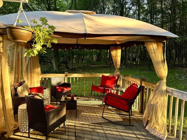 The lounge area in the gazebo is a comfortable spot to enjoy a morning cup of coffee, watch for animals passing through the woods or enjoy views of the lake