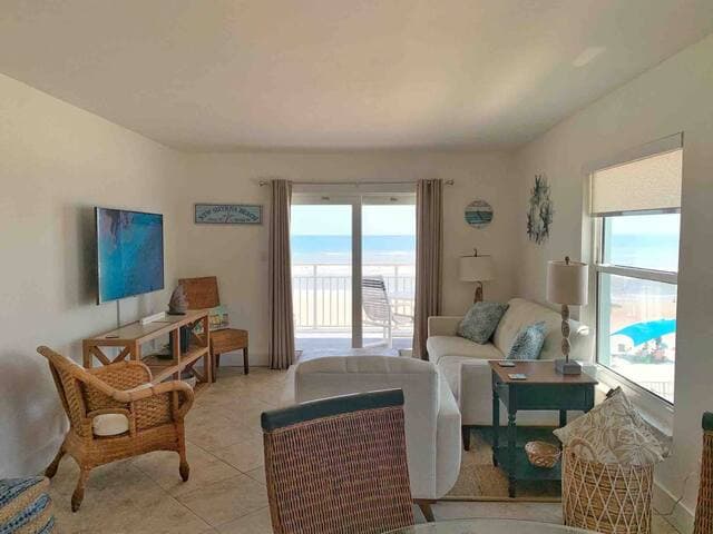 Expansive views from all brand new windows & sliding door! Open floor plan with new modern livingroom rich in wood and linen textures. Glasstop dining table with rattan chairs make this space perfect for families to spread out!