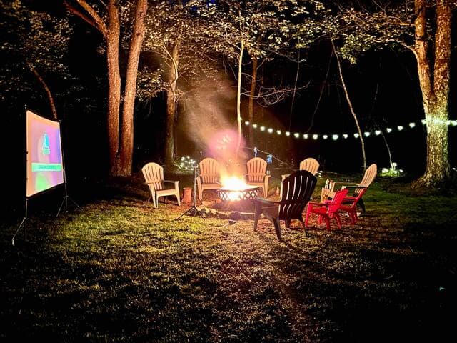 Set up the outdoor movie screen and projector for a movie night by the fire!