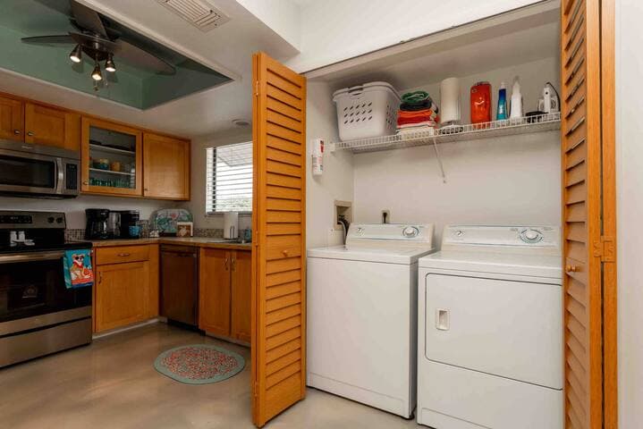 Well-appointed laundry area with full-size washer & dryer inside condo.