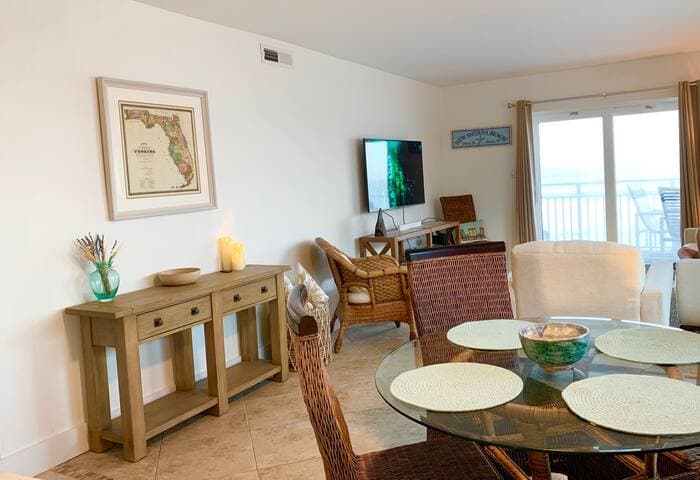 Updated livingroom with inviting entry, extra seating, NEW! 55” LG tv and walkout to balcony overlooking the direct oceanfront on our no-drive section of NSB!