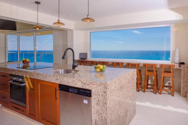 Unbelievable view from our full size kitchen which includes an oven, dishwasher, full size sink, stove top, fridge, coffee maker and microwave. All essentials you need to cook, aka pots, pans, dishes, cups, glasses. We even have a water cooler.