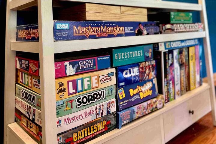 The board game cabinet is fully stocked with unique games for kids and adults!