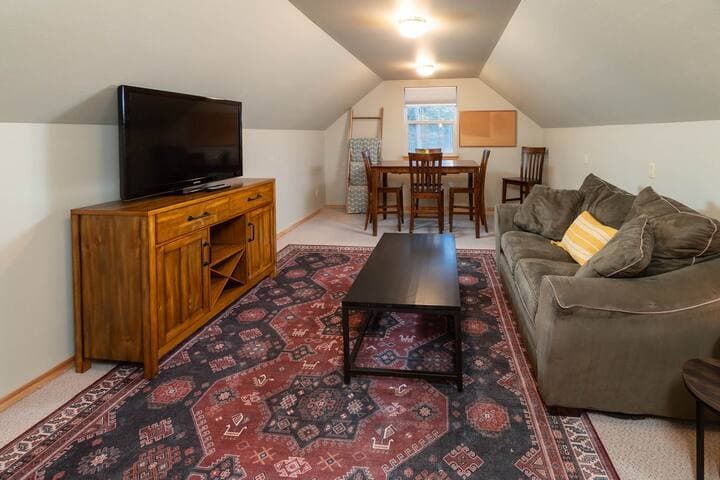 Suitable as a workspace or playroom for kids. Directly across from the bedroom with four beds. Amenities are printer stored in the cabinet, SmartTV, extra blankets, and the option to set up an air mattress if needed.