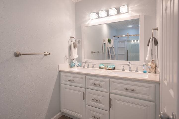 The first-floor bathroom offers a vacation-vibe with plenty of space to get ready with shampoo and conditioner provided.