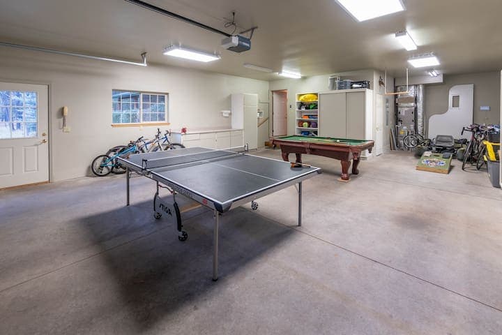 Ping pong table, pool table, cornhole, basketballs, soccer ball, pogo stick, crashpad for rock climbing, bikes, blowup raft with air pump, and two coolers.
EV-Charger is located by the garage door.