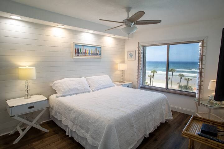 Master bedroom with bay window and plantation shutters that keeps the room dark.
