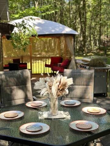 The outdoor dining area on the deck is a great spot to enjoy a meal cooked on the propane grill