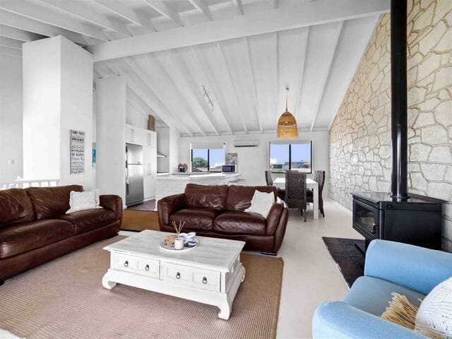 The spacious upstairs open plan living area leads onto a balcony with a view of the Indian Ocean. While washing up at the sink, you can gaze at the ocean from the kitchen.