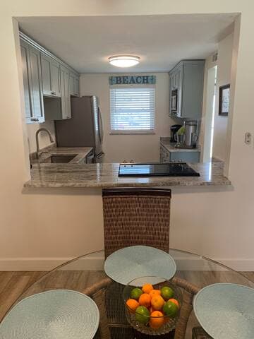 Open floor concept connects those in the kitchen with those in the dining & living room area.