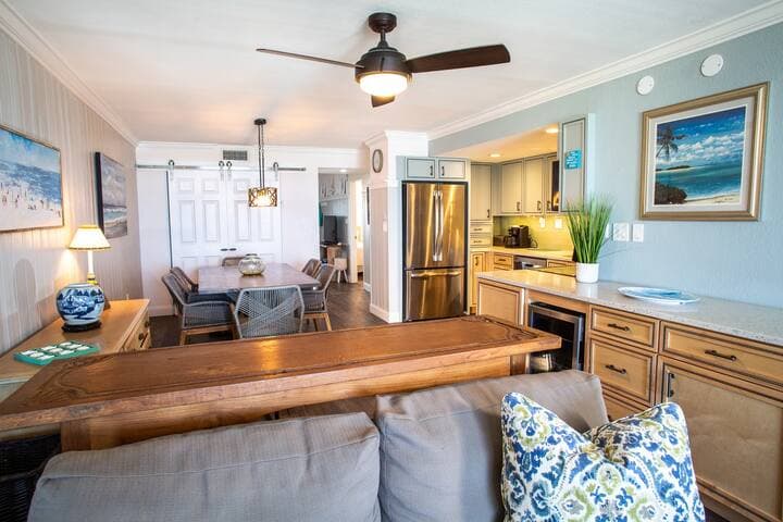 Open living and dining room with bar. Lots of storage, too!