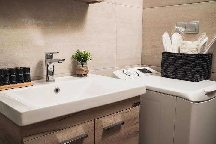 Bathroom with a washing machine and extra washing capsules
