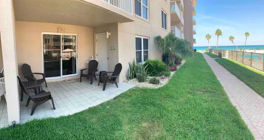 Steps to the beach! Poolside patio with seating for 4 to relax with a cold beverage & enjoy some time in the shade.