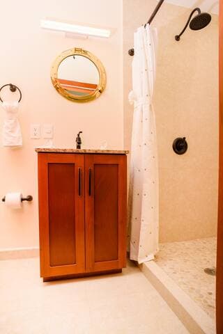 Stylish downstairs bathroom with vanity and storage.