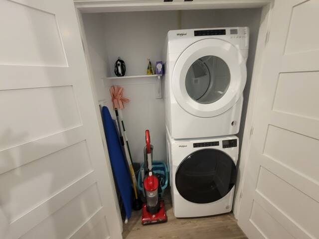 Full-size washer and dryer, ironing board and iron, vacuum, broom and laundry basket.