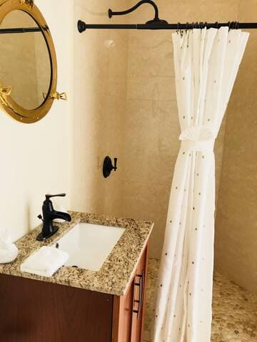 Downstairs bathroom with new tile, granite and fixtures.