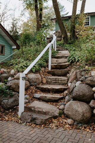 Natural stone steps lead down to the property. These steps are NOT suitable for those with mobility issues.