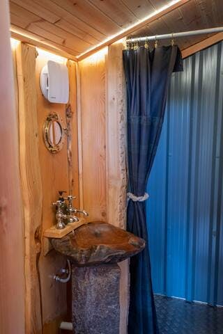 Showers are a generous size and lined with tin, with bespoke metal trays, hand-made waxed cotton shower curtains and hot, plentiful Grohe showers. The compost loo is in here too and is a doddle to use