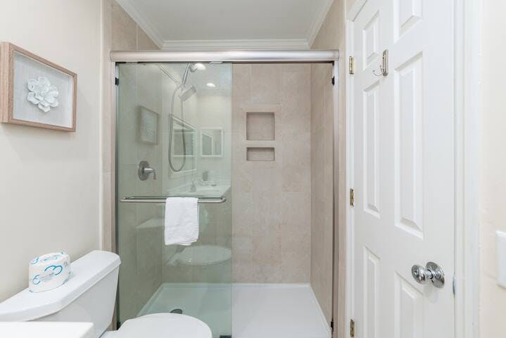 A great spa-like experience with dual shower head systems in a walk-in shower enclosure.
