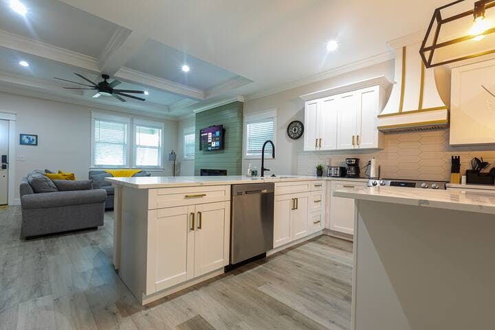 Discover culinary bliss in this open-concept kitchen. A large, sunken sink and quiet dishwasher effortlessly handle the cleaning of provided dishes and cookware. Enjoy cooking while socializing with the whole family.