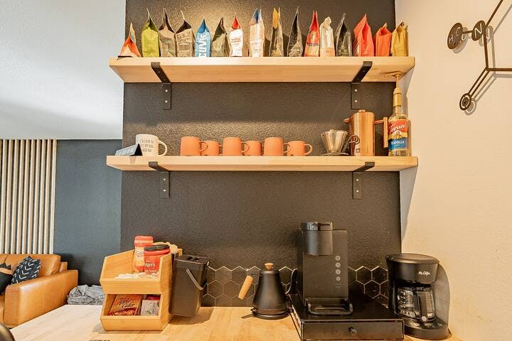 The well-stocked "coffee nook" is equipped with everything you need: a carafe, a Keurig, and an electric kettle for tea and pour-over coffee, a variety of creamers, teas, and non-caffeinated options. It's the perfect way to start your day!