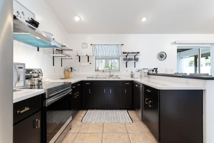 Open, bright, clean, fully stocked kitchen provides the perfect spot for brewing your morning coffee or preparing the evening meal and cocktails.